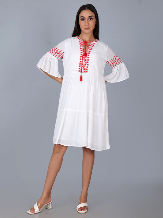 Tiered dress with embroidery details in white . Fully lined