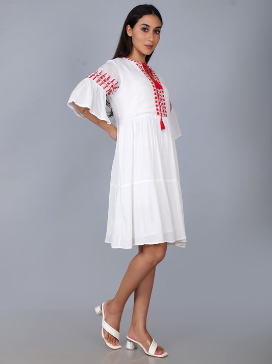 Tiered dress with embroidery details in white . Fully lined